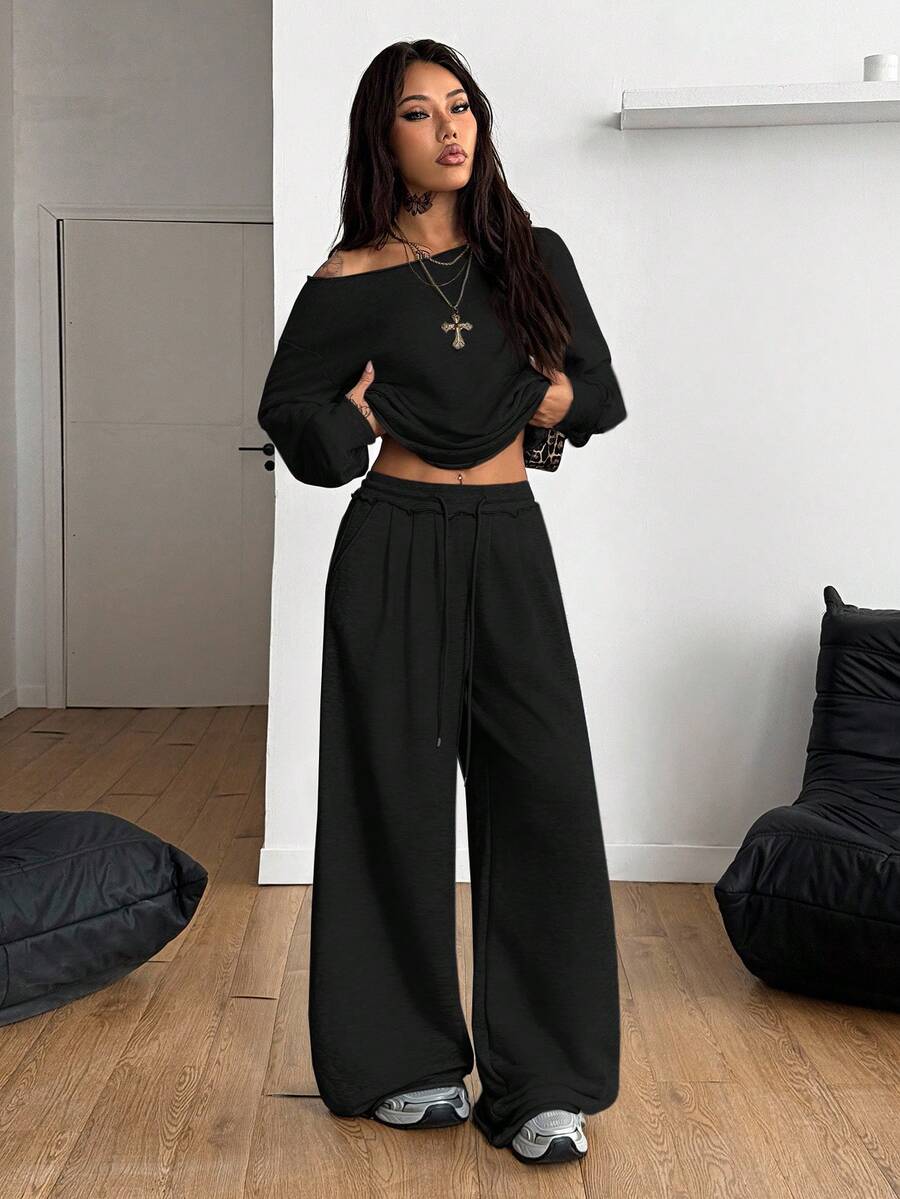Women's two-piece casual lounge set featuring a loose drop-shoulder long sleeve sweatshirt and high-waist drawstring sweatpants with pockets.