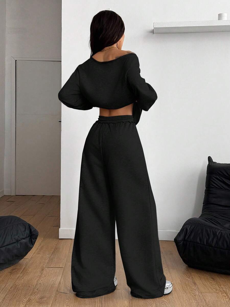Women's two-piece casual lounge set featuring a loose drop-shoulder long sleeve sweatshirt and high-waist drawstring sweatpants with pockets.