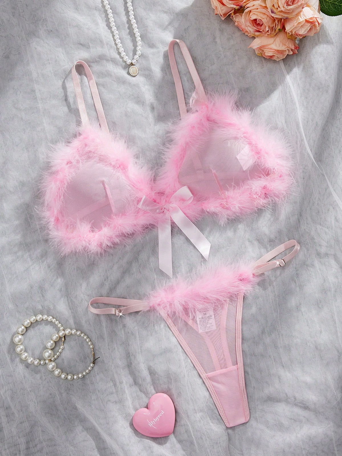 Pink sheer mesh two-piece lingerie set featuring a wireless triangle bralette with fluffy trim and a matching low-rise thong panty.