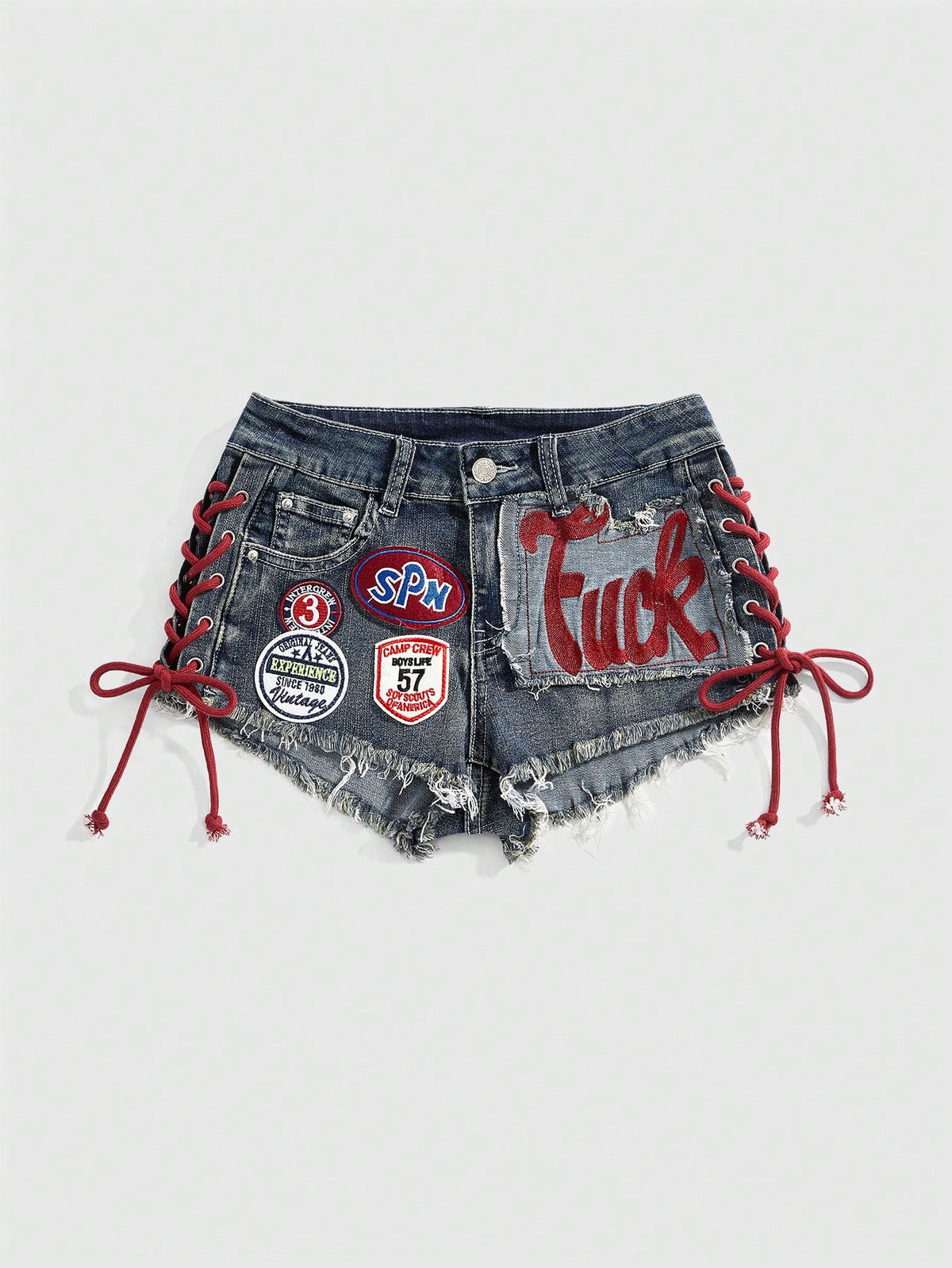 Women's Y2K low waist camo mini skort shorts featuring lace-up knot details, grommet eyelets, graphic lettering pattern, and a zipper fly.