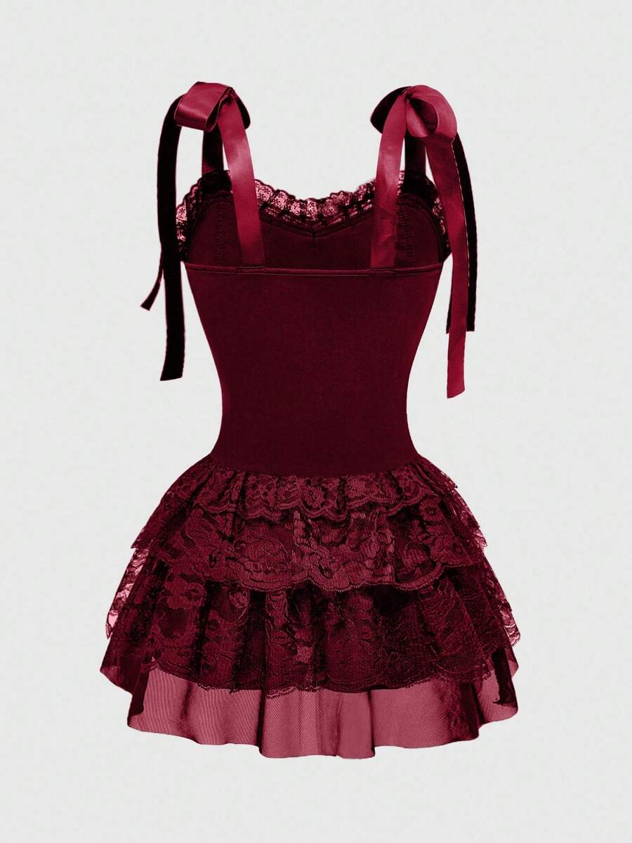 Gothic velvet halter mini dress with contrast lace trim, bow detail, lace-up accents, arm sleeves, layered hem, and cross pendant.