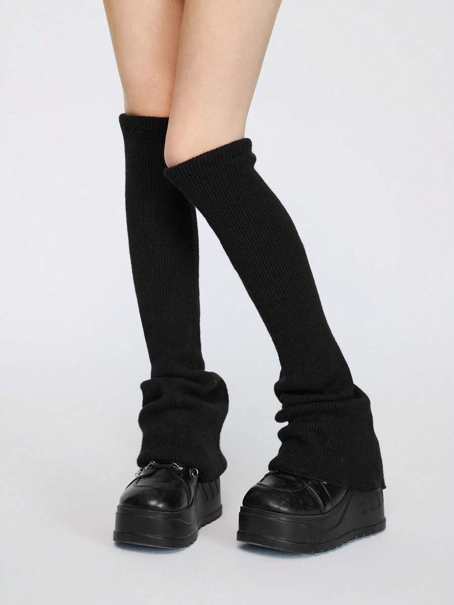 Pair of women's extra long knitted leg warmers featuring a gothic grunge design with subtle ruffle detailing.
