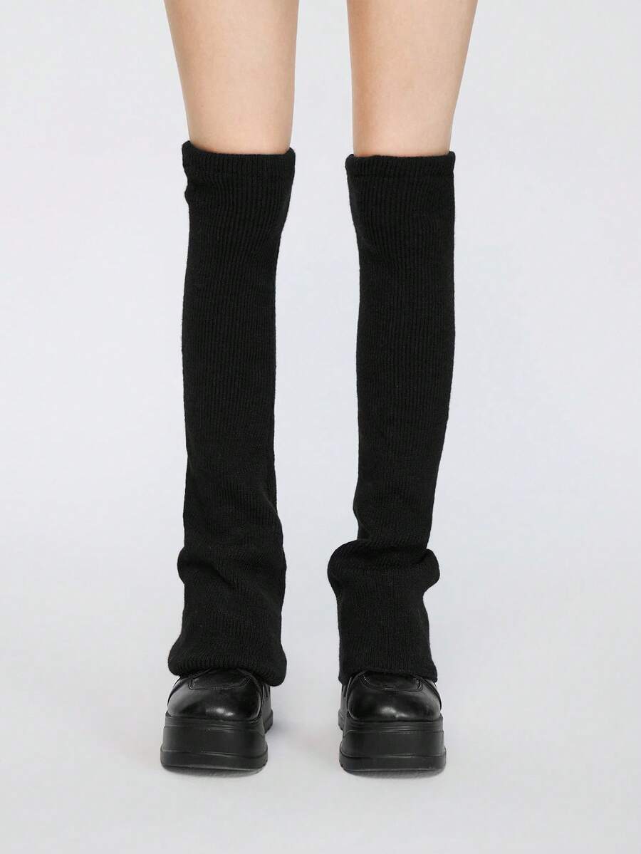 Pair of women's extra long knitted leg warmers featuring a gothic grunge design with subtle ruffle detailing.