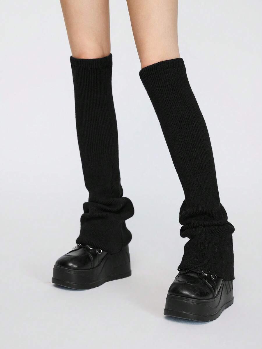 Pair of women's extra long knitted leg warmers featuring a gothic grunge design with subtle ruffle detailing.