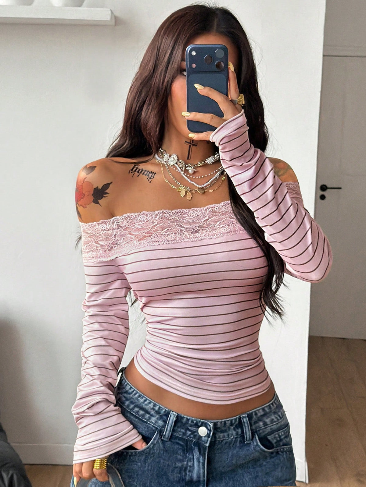 Women's slim fit off the shoulder long sleeve knitted top featuring contrast lace trim and ruched accents.