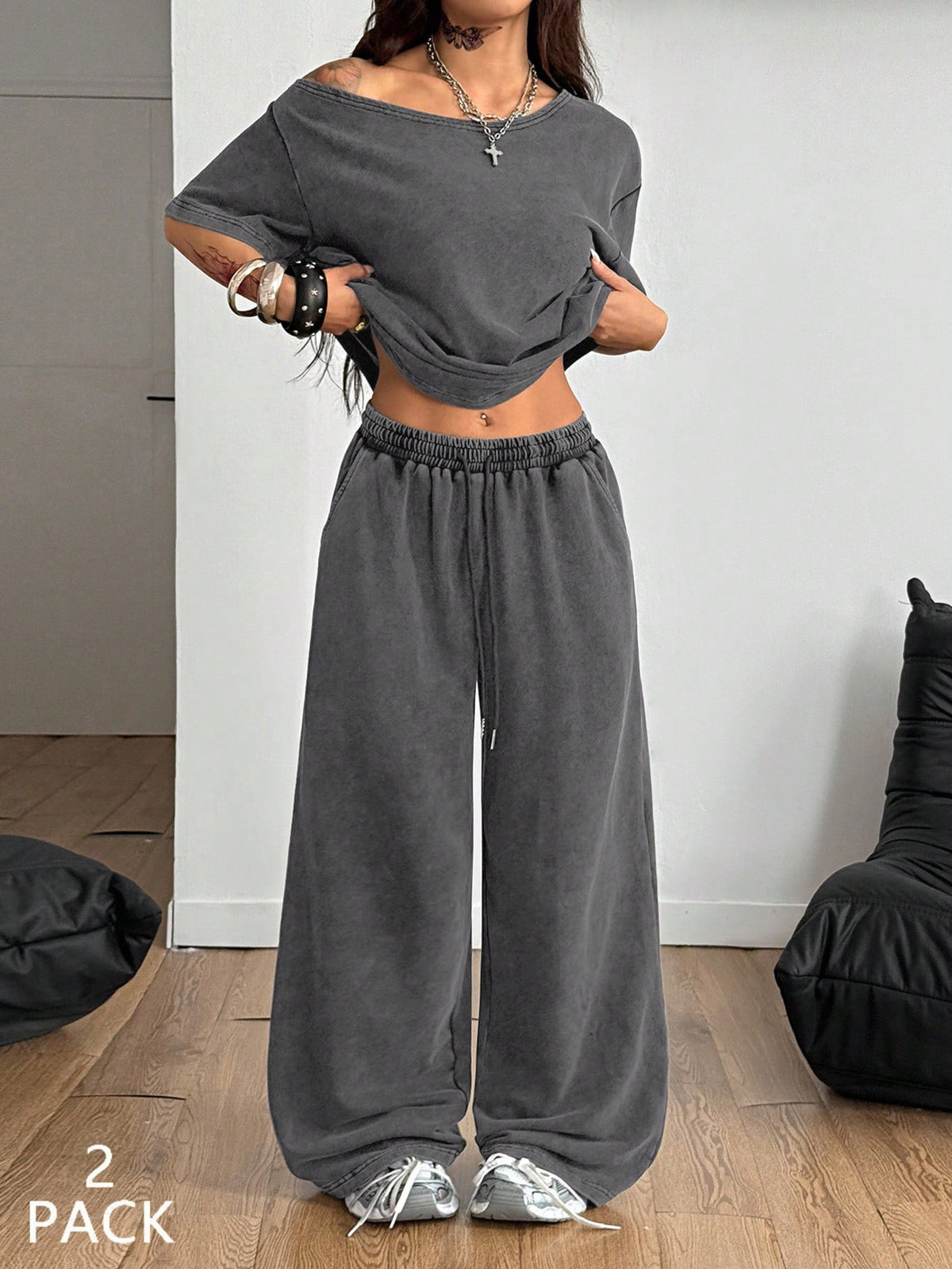 Women's two-piece outfit featuring an oversized asymmetrical neck t-shirt and matching wide-leg drawstring sweatpants.