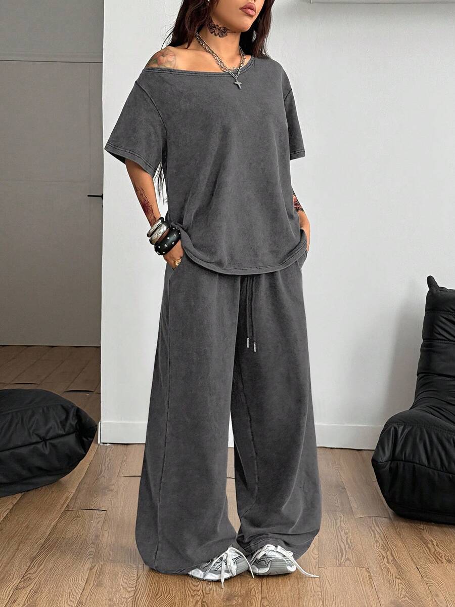 Women's two-piece outfit featuring an oversized asymmetrical neck t-shirt and matching wide-leg drawstring sweatpants.