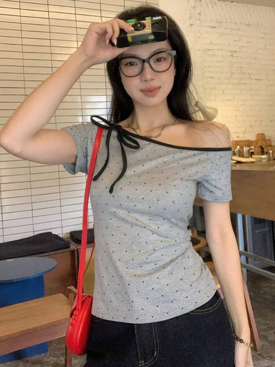 Women's casual short sleeve t-shirt with an asymmetrical neck in a loose fit knitted fabric.