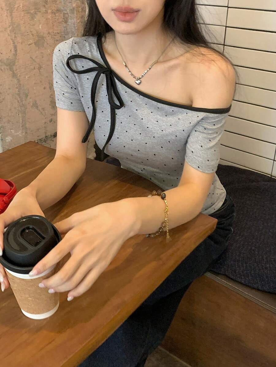 Women's casual short sleeve t-shirt with an asymmetrical neck in a loose fit knitted fabric.