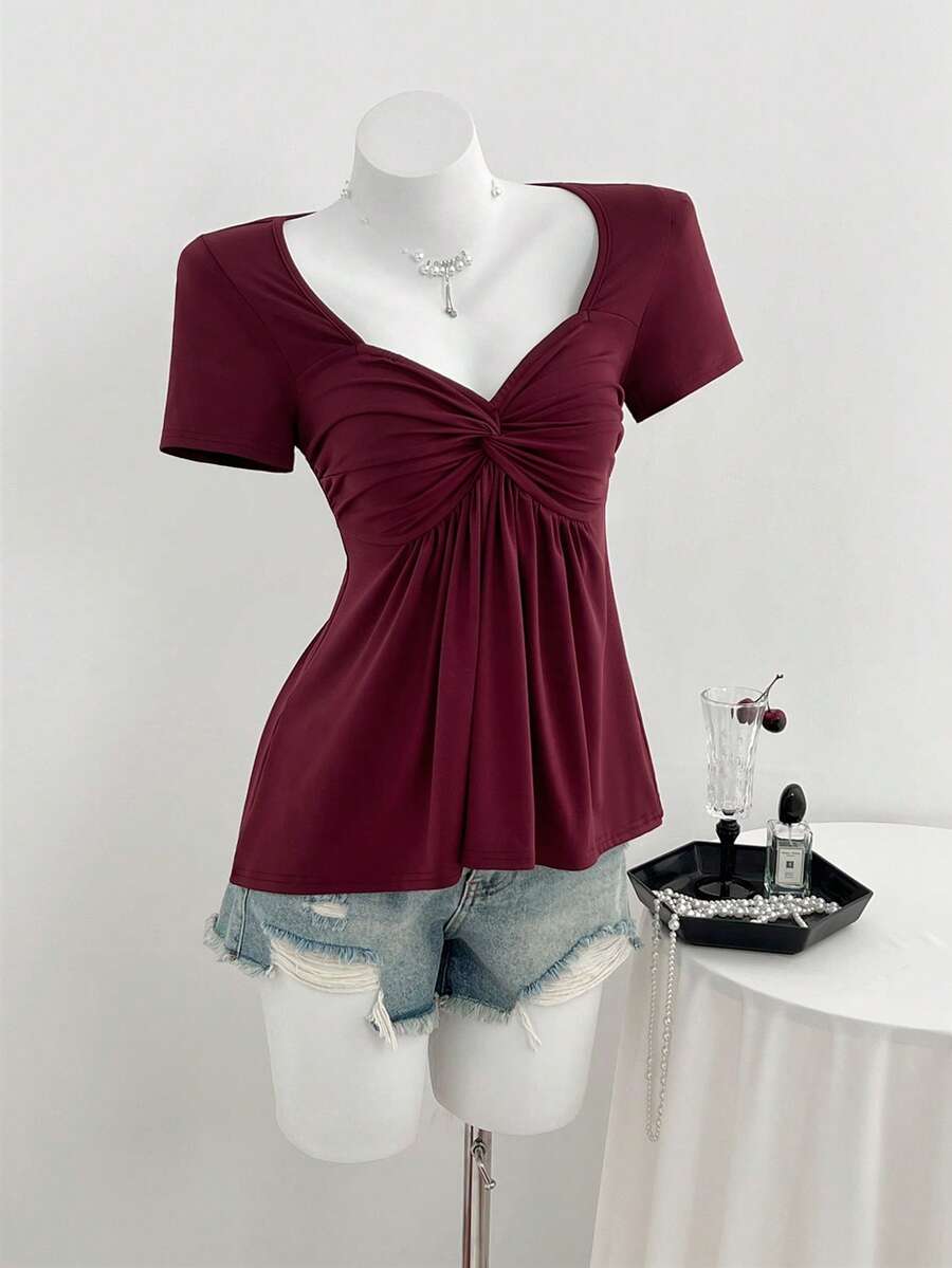 Women's short sleeve V-neck T-shirt featuring a front twist knot detail and slim fit.