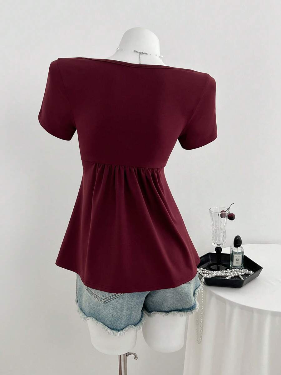 Women's short sleeve V-neck T-shirt featuring a front twist knot detail and slim fit.