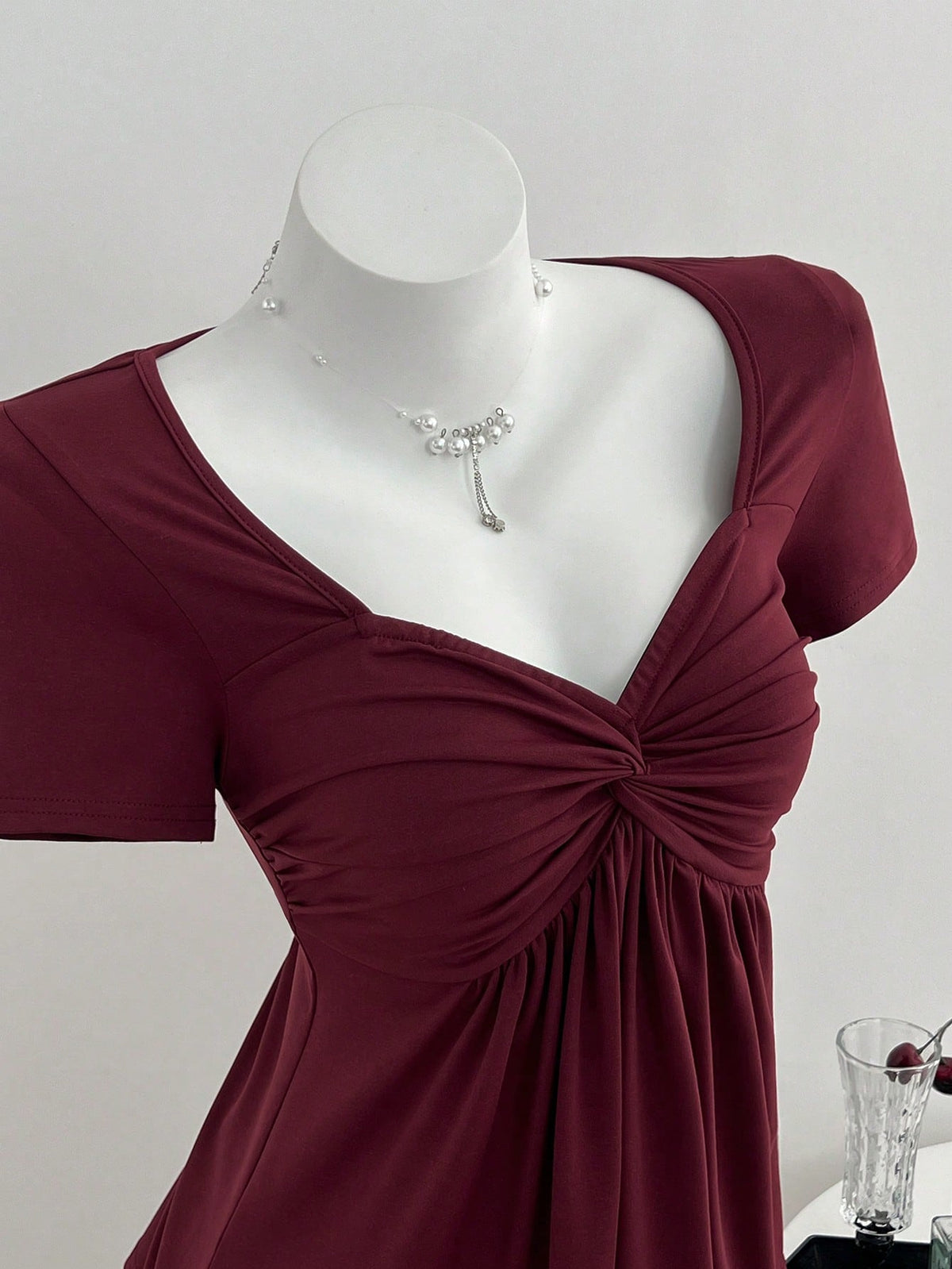 Women's short sleeve V-neck T-shirt featuring a front twist knot detail and slim fit.