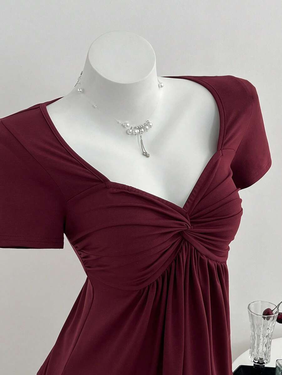 Women's short sleeve V-neck T-shirt featuring a front twist knot detail and slim fit.
