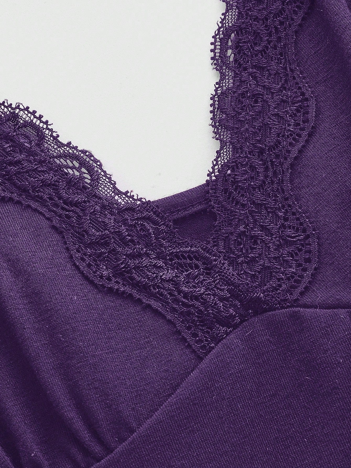 Women's spaghetti strap camisole with contrast lace patchwork, slim fit silhouette, plain design, and flared hem.