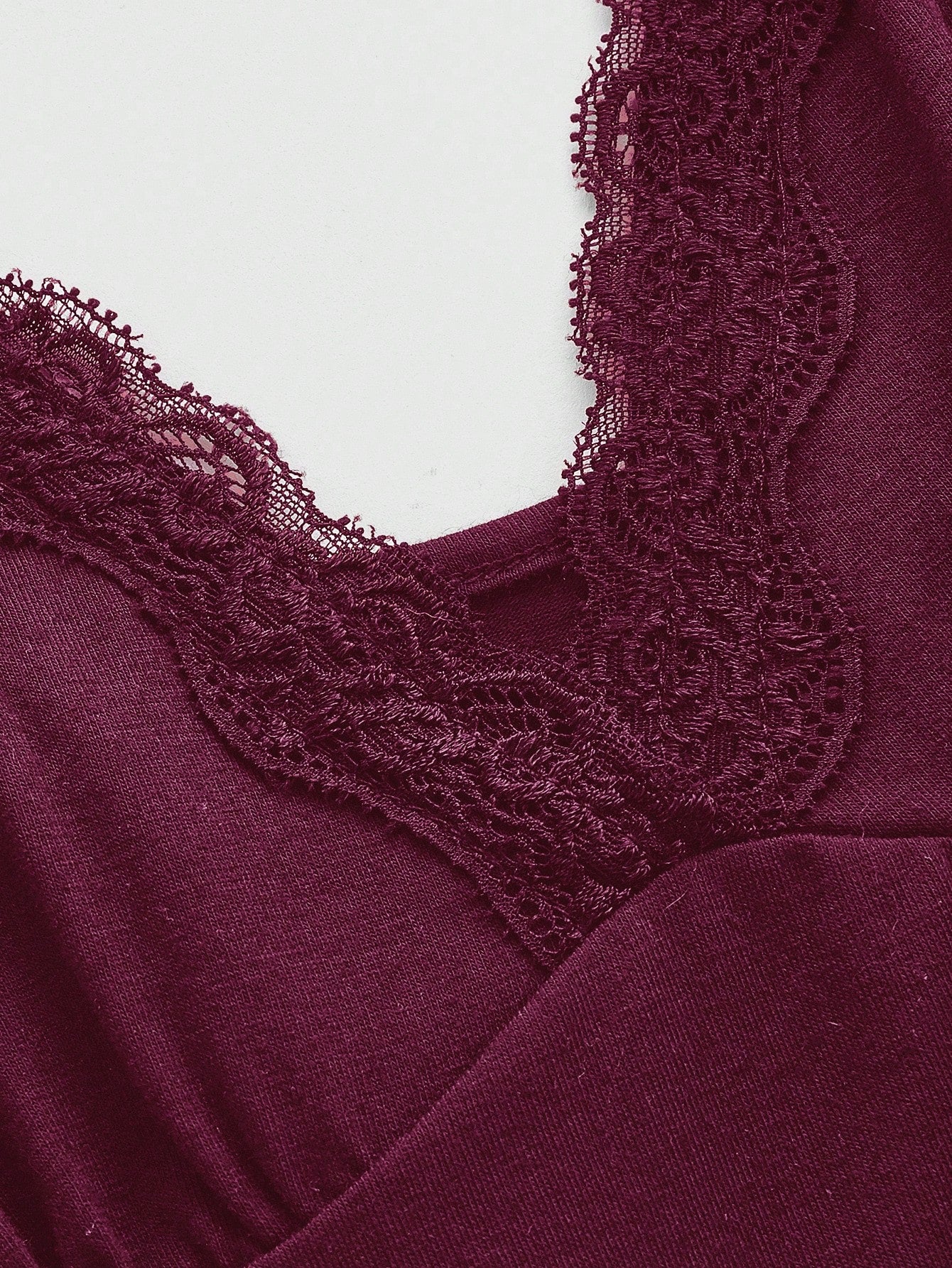 Women's spaghetti strap camisole with contrast lace patchwork, slim fit silhouette, plain design, and flared hem.