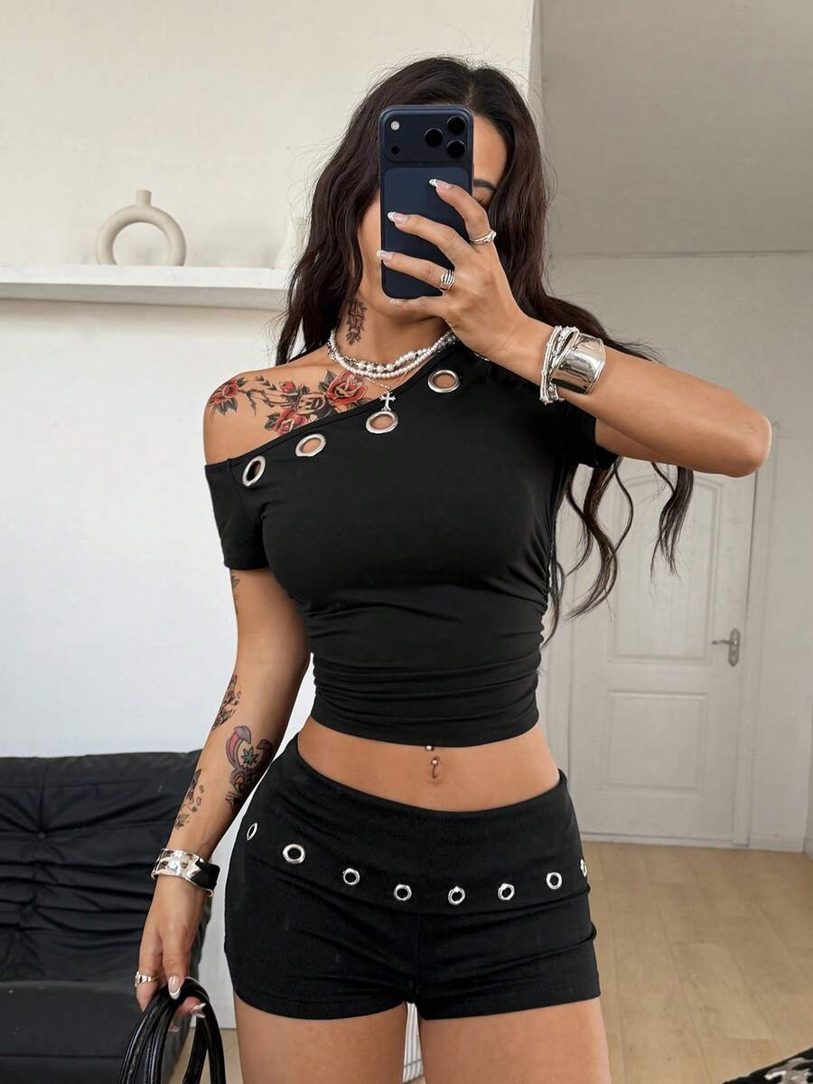 Women's black ultra low rise mini shorts with grommet eyelet and rib-knit details, zipper fly closure, skinny straight-leg fit, and plain knitted fabric.