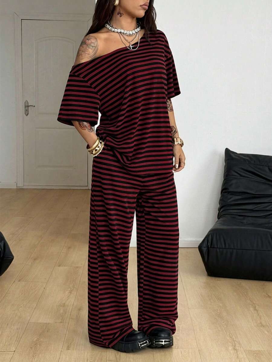Women's two-piece outfit featuring an oversized asymmetrical neck t-shirt and matching wide-leg drawstring sweatpants.