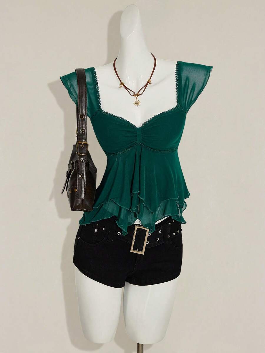 Black slim fit women's ruched front camisole tank top featuring contrast mesh inserts, square neckline, and an asymmetrical crop hem.