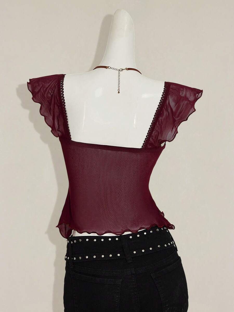 Black slim fit women's ruched front camisole tank top featuring contrast mesh inserts, square neckline, and an asymmetrical crop hem.