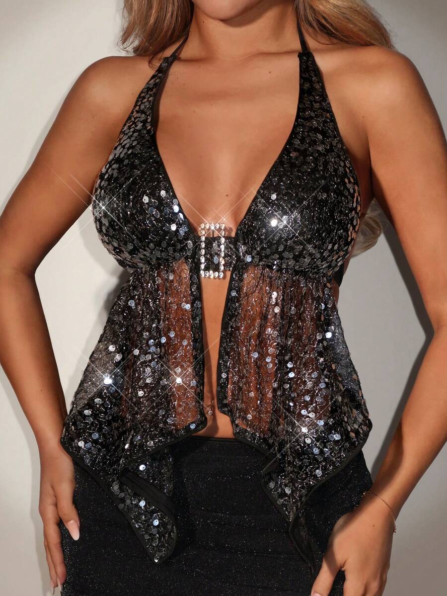 Women's black sequin backless halter top featuring an asymmetrical hem and shiny geometric sequin detailing.