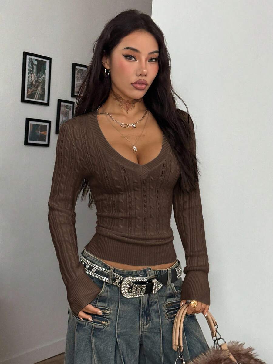 Women's slim fit cable-knit long sleeve sweater featuring a V-neckline and ribbed knit details.