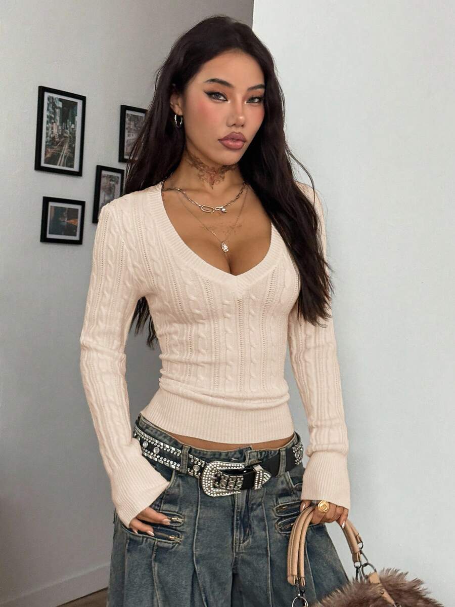 Women's slim fit cable-knit sweater with a V-neckline and long sleeves in solid green rib knit fabric.
