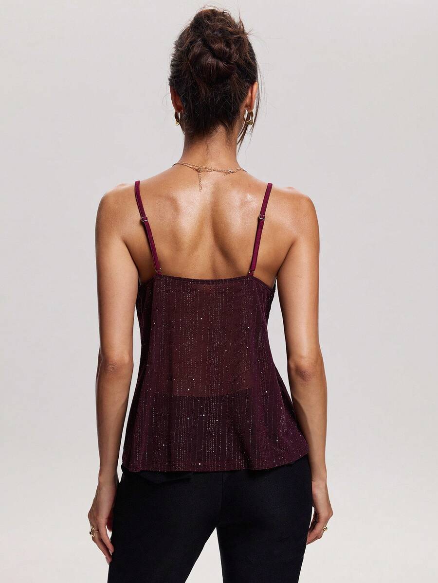 Women's backless spaghetti strap camisole top featuring contrast lace details, knot accents, and a slim fit.