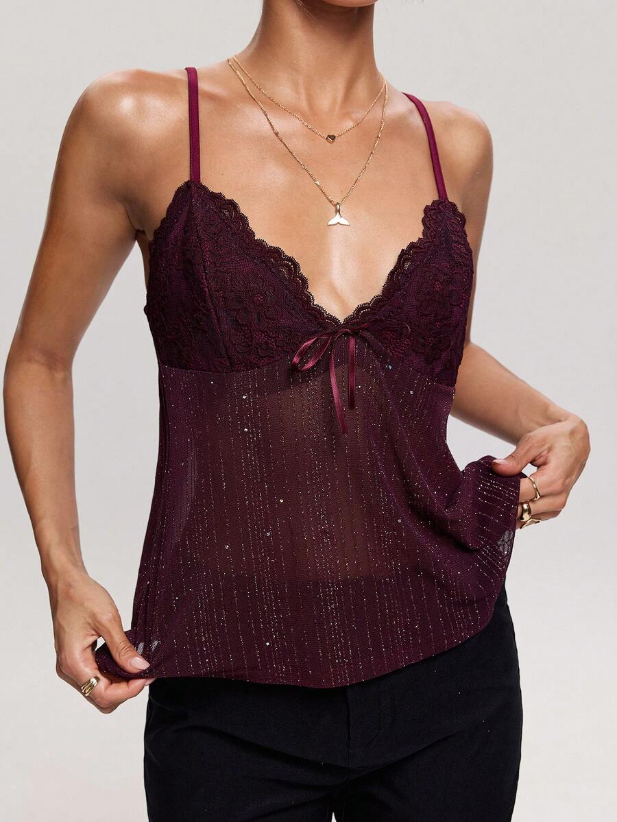 Women's backless spaghetti strap camisole top featuring contrast lace details, knot accents, and a slim fit.