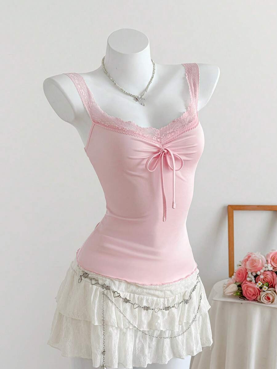 Women's slim fit casual camisole featuring wide shoulder straps, contrast lace trim, a front knot, and ruched details.