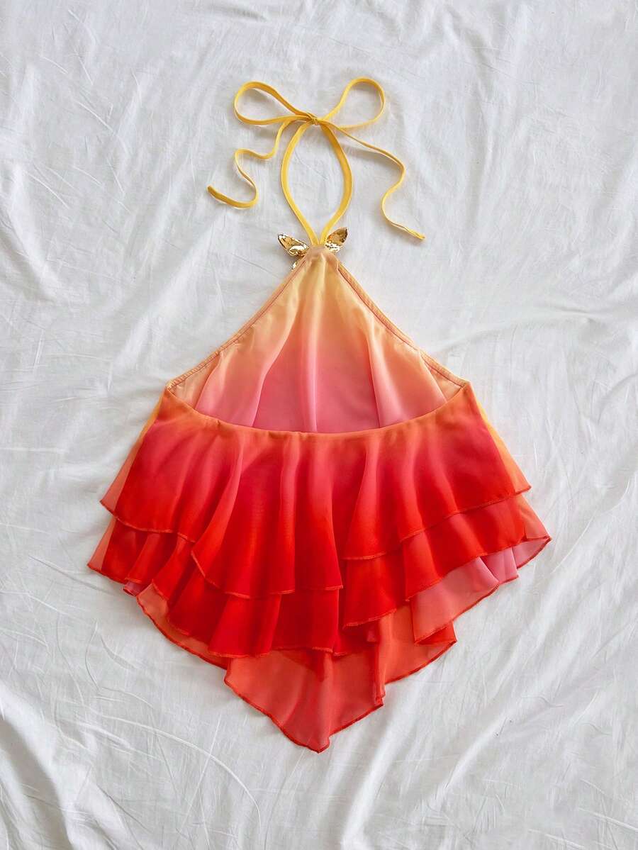 Women's gradient halter top with draped neck, butterfly metal accent, backless cut, and asymmetrical hem