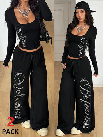 Women's black two-piece casual outfit featuring a long sleeve scoop neck letter print t-shirt and matching wide leg sweatpants made of knitted cotton blend fabric.