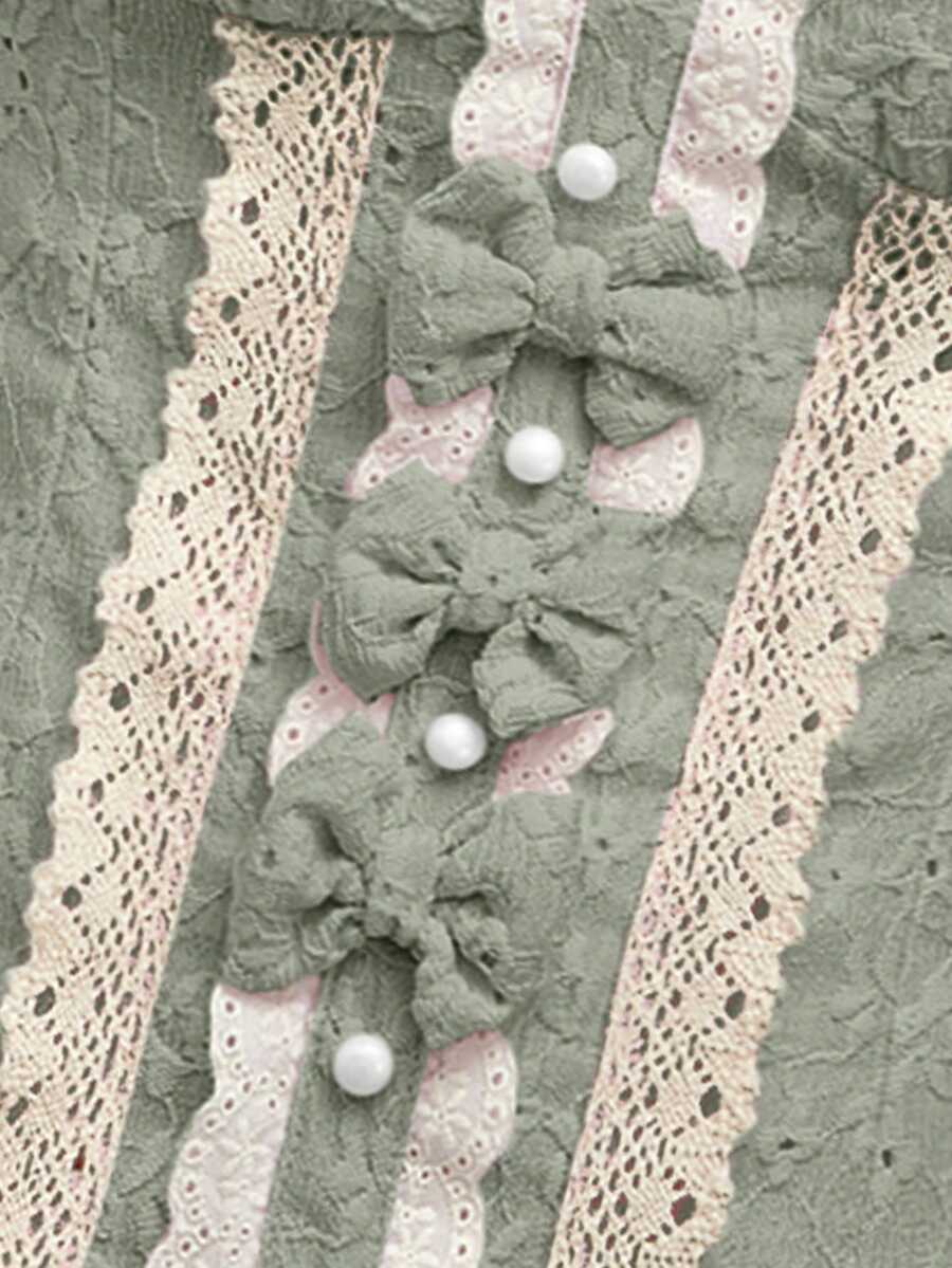 Women's slim fit short sleeve blouse featuring a square neckline, puff sleeves, lace-up front detail, and a frill ruffle hem.