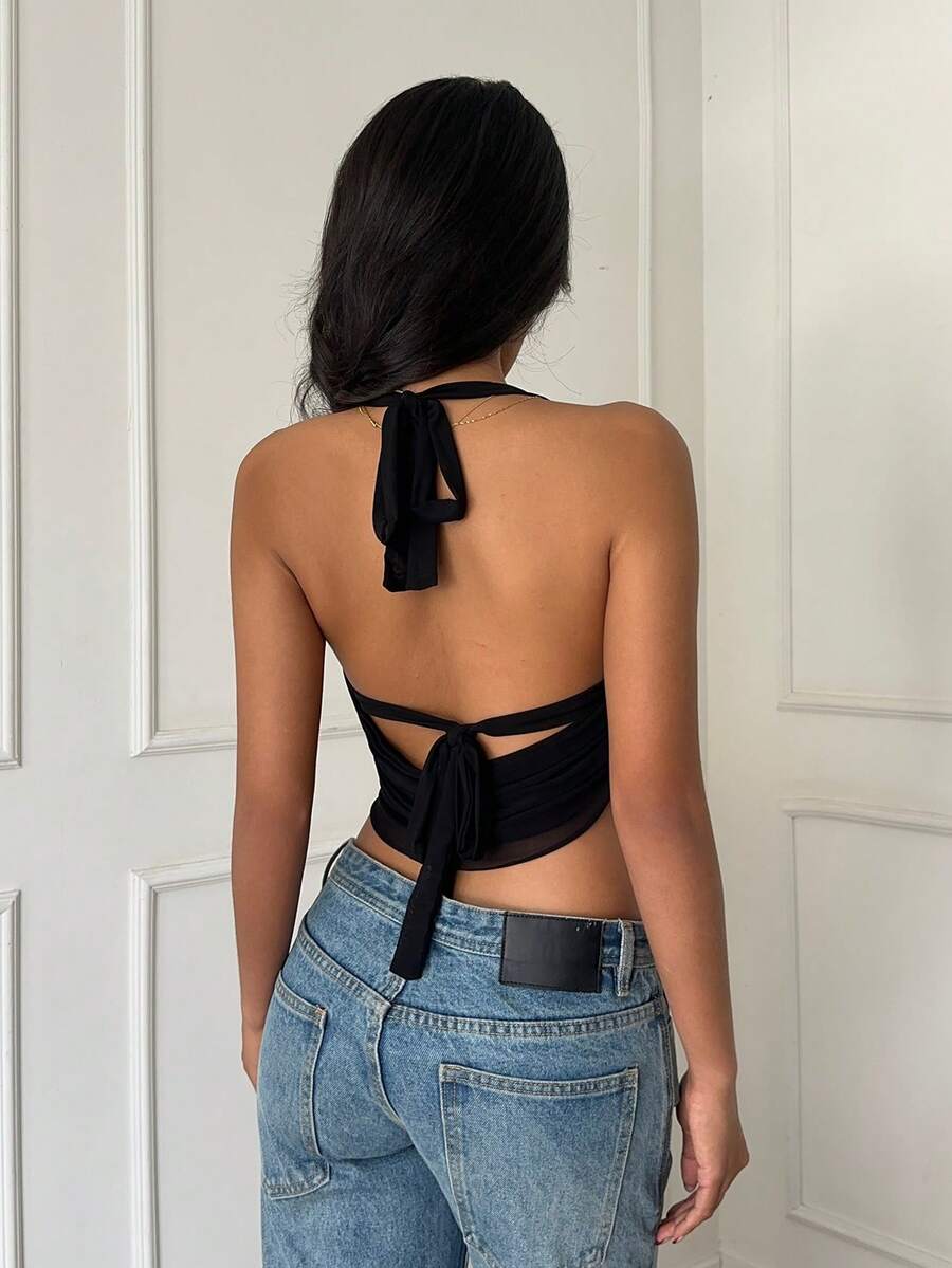 Women's black halter cup-style crop camisole top with a backless bralette design and draped front detail.
