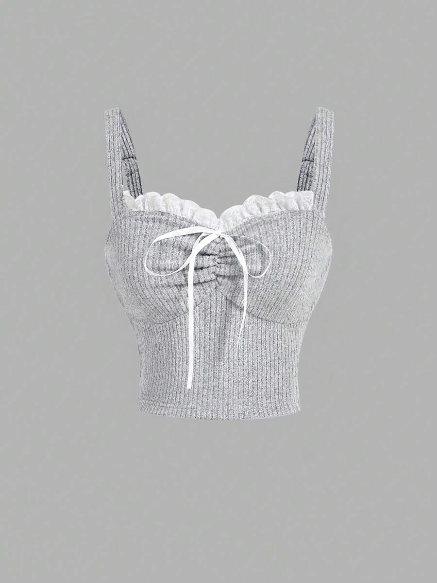 Black crop camisole top for women featuring shoulder straps, cold shoulder sleeves, drawstring detail, and frill trim on plain knitted fabric.