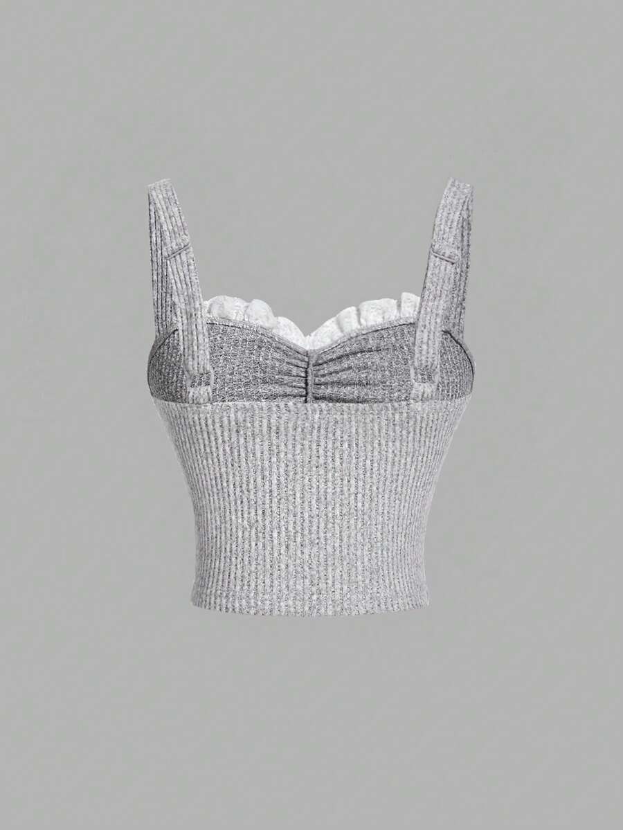 Black crop camisole top for women featuring shoulder straps, cold shoulder sleeves, drawstring detail, and frill trim on plain knitted fabric.