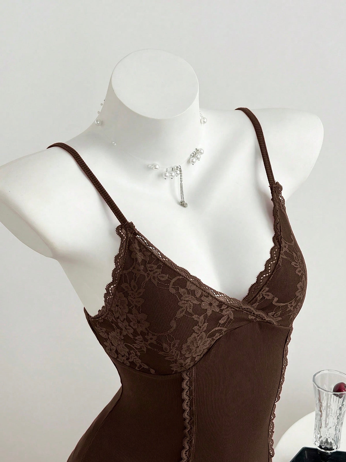 Women's slim fit backless cami tank top with contrast lace patchwork details, spaghetti straps, and high-stretch knitted ribbed fabric.