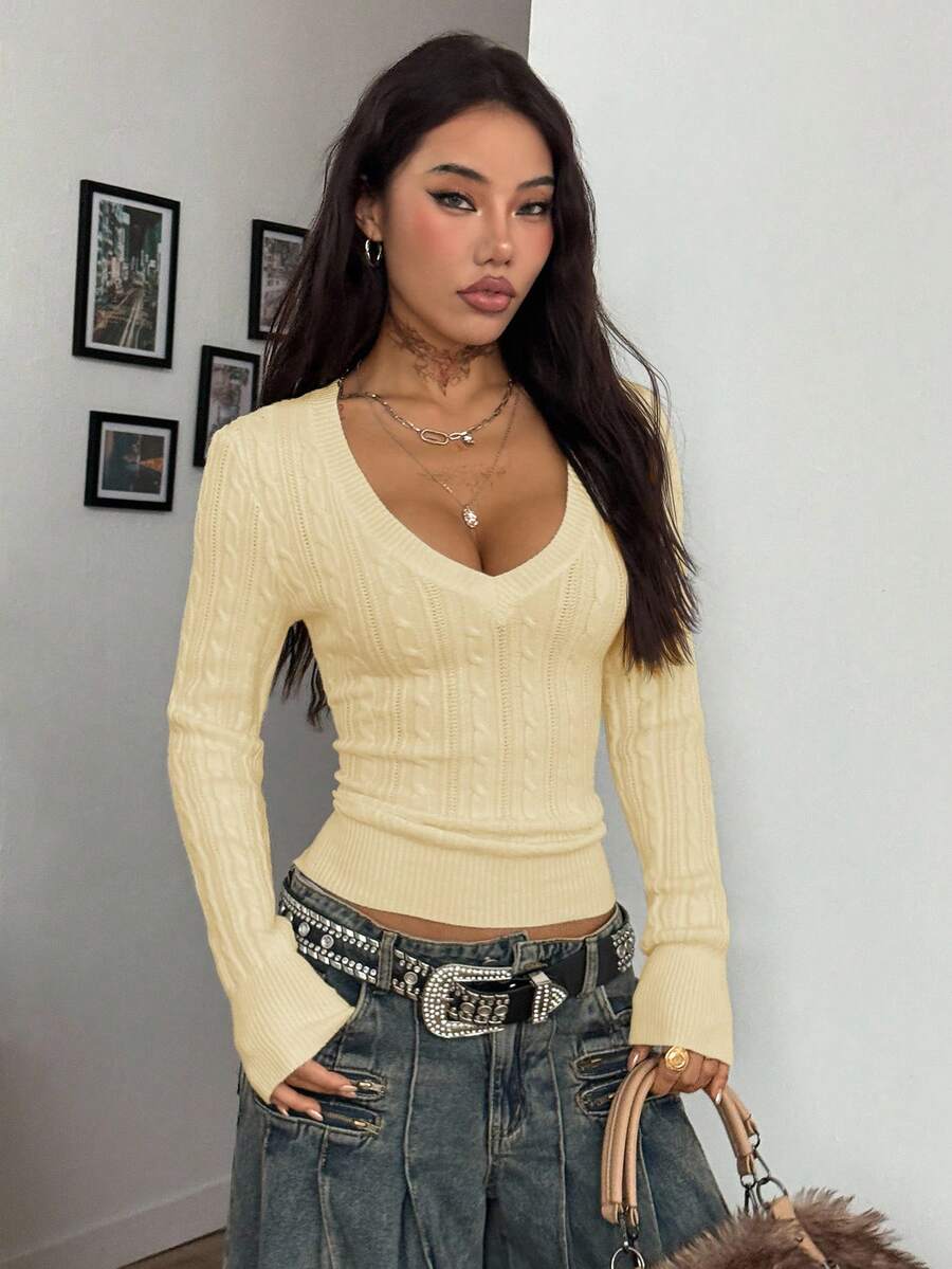 Women's slim fit cable-knit sweater with a V-neckline and long sleeves in solid green rib knit fabric.