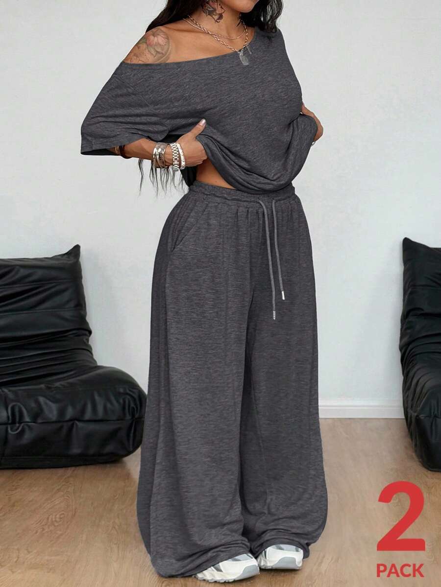 Women's casual two-piece outfit featuring a loose short-sleeve asymmetrical neck t-shirt and matching long wide leg pants with pockets.