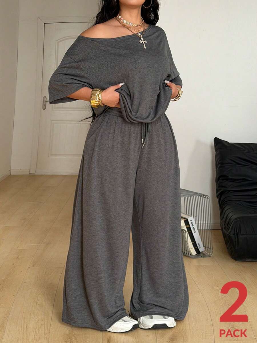 Women's casual two-piece outfit featuring a loose short-sleeve asymmetrical neck t-shirt and matching long wide leg pants with pockets.