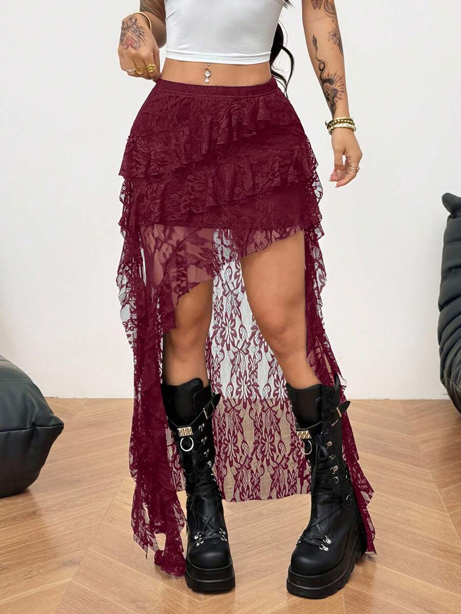Women's low rise asymmetrical long skirt with ruffle hem detailing in semi-sheer knitted fabric.