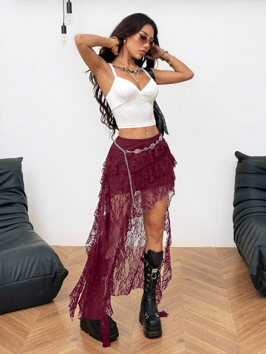 Women's low rise asymmetrical long skirt with ruffle hem detailing in semi-sheer knitted fabric.