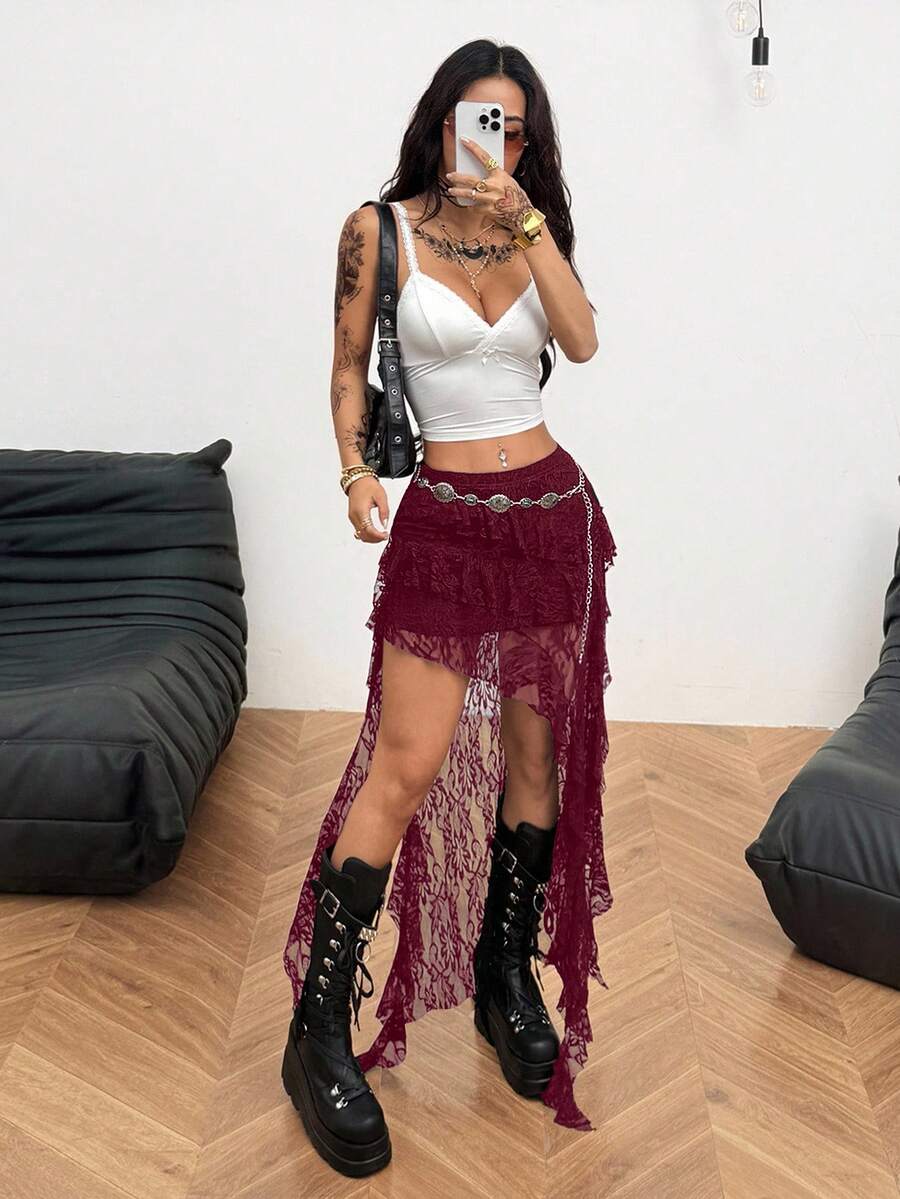 Women's low rise asymmetrical long skirt with ruffle hem detailing in semi-sheer knitted fabric.