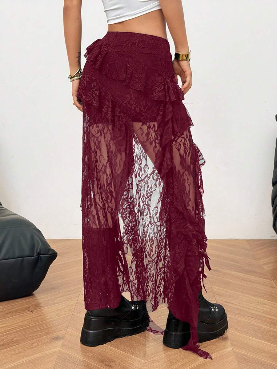 Women's low rise asymmetrical long skirt with ruffle hem detailing in semi-sheer knitted fabric.