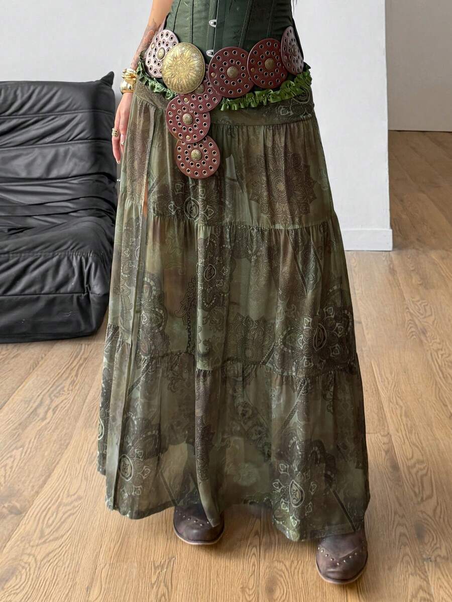 Women's low rise flared long skirt featuring an all-over print, split thigh accent, and textured semi-sheer fabric.