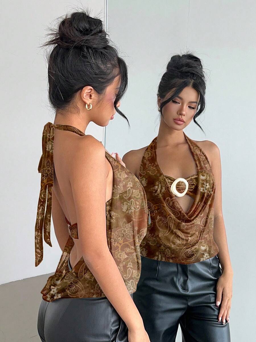 Brown and white polka dot semi-sheer halter camisole top with a plunging neckline, backless design, draped front, and metallic studded embellishments.