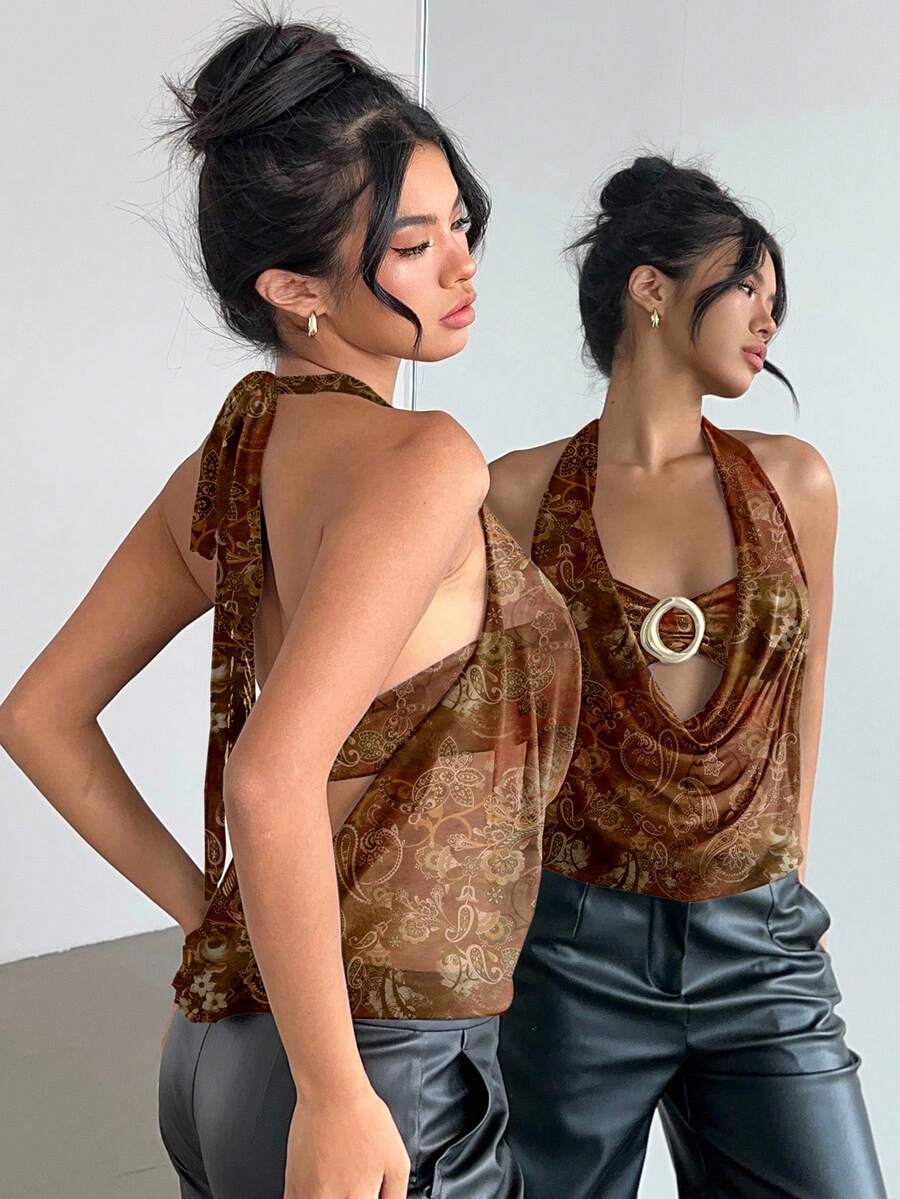 Brown and white polka dot semi-sheer halter camisole top with a plunging neckline, backless design, draped front, and metallic studded embellishments.