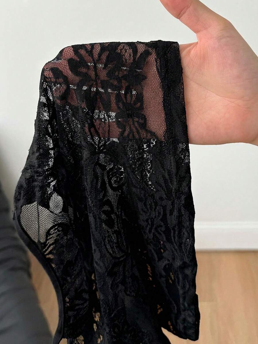 Women's black lace crop cami top featuring spaghetti straps, cold shoulder sleeves, and a sheer backless design.