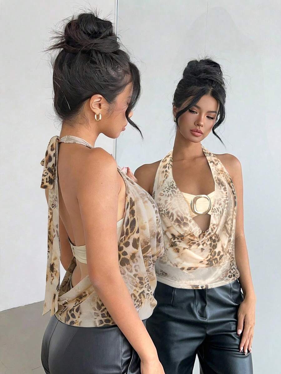 Brown and white polka dot semi-sheer halter camisole top with a plunging neckline, backless design, draped front, and metallic studded embellishments.