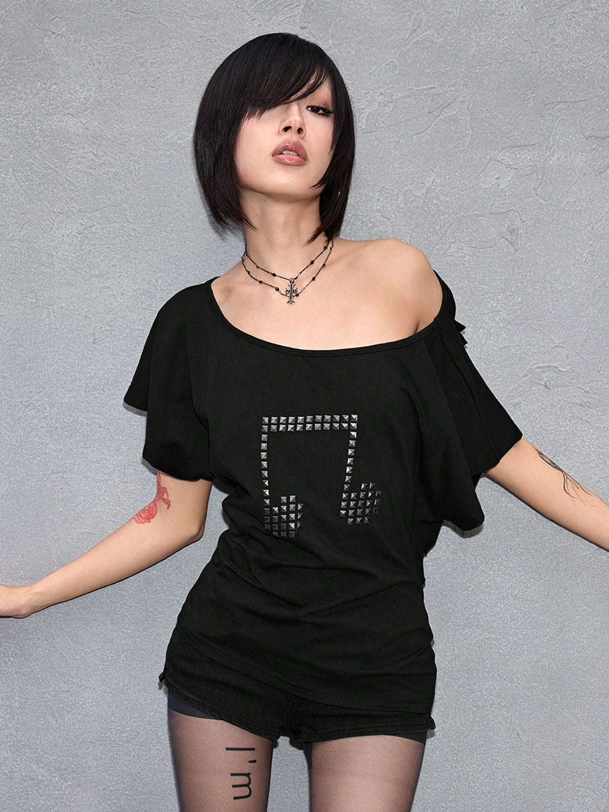 Women's grunge punk style short sleeve t-shirt featuring an asymmetrical neckline, hollow-out cut detail, and relaxed batwing sleeves in a soft cotton stretch fabric.