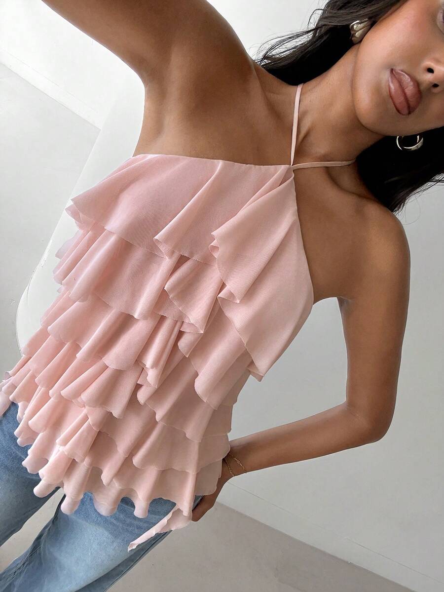 Women's sleeveless halter neck top featuring tiered ruffle layers, a backless cut, and an asymmetrical hem.